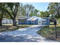 Cozy single-story home with a covered parking area and mature trees at 1006 San Domingo Rd, Orlando, FL 32808