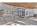 Spacious living room featuring wood floors, a fireplace, and access to an outdoor patio at 104 Wild Plum Ln, Longwood, FL 32779