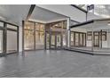 A spacious outdoor patio features multiple doors and windows, perfect for enjoying the scenery at 104 Wild Plum Ln, Longwood, FL 32779