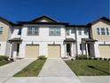 Charming two-story townhome boasts a two-car garage, well-kept lawn, and modern design at 1613 Pelican Dr, Davenport, FL 33896