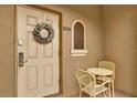 Inviting entryway featuring a decorative wreath, a small table and chairs, and the unit number above the door at 2234 Calabria Ave, Davenport, FL 33897