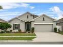 Charming single Gathering home with a two car garage, manicured lawn and beautiful flowerbeds at 2559 Eagle Bay Blvd, Kissimmee, FL 34743