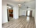 Open-concept living room boasting modern lighting, a ceiling fan, and beautiful wood-look flooring at 305 S Palm Ave, Kissimmee, FL 34741
