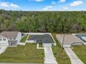 Aerial view of house featuring fenced in backyard and mature landscaping in quiet neighborhood at 33 Perch Dr, Kissimmee, FL 34759
