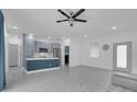 Open-concept living space with tile floors, kitchen island, recessed lighting, and ceiling fan at 33 Perch Dr, Kissimmee, FL 34759