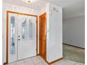 Bright foyer featuring tile flooring, white trim, and double-door entry with decorative glass panels at 3619 Willow Lake Ct, St Cloud, FL 34769