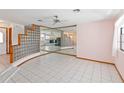 Open-concept living area with tile floors, glass brick detail, mirrored wall, and lots of natural light at 3619 Willow Lake Ct, St Cloud, FL 34769