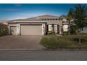 Charming single-story home featuring a three-car garage and well-manicured landscaping at 4311 Via Cavour Ct, Kissimmee, FL 34759