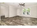 Bright living room features new wood-look floors, crown moulding, and lots of natural light at 4626 Bunting Ave, Orlando, FL 32812