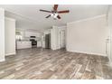 Open concept with wood-look floors connects the living room and kitchen with stainless appliances at 4626 Bunting Ave, Orlando, FL 32812