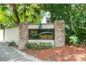 A sign for Bay Springs, framed by brick columns and lush greenery at 5517 Bay Lagoon Cir, Orlando, FL 32819