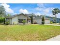 Well-maintained single-Gathering home with green lawn, trees, and a brick driveway at 5517 Bay Lagoon Cir, Orlando, FL 32819