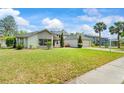 Landscaped single-Gathering home with manicured lawn, mature trees, and a brick driveway at 5517 Bay Lagoon Cir, Orlando, FL 32819