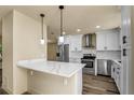 Modern kitchen with stainless steel appliances, white cabinets, and sleek countertops at 628 Eastwood Ct, Altamonte Springs, FL 32714