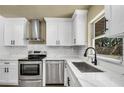 Well-equipped kitchen with stainless appliances, modern faucet, and white countertops at 628 Eastwood Ct, Altamonte Springs, FL 32714
