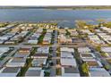 An aerial view of a mobile home community near a scenic lake at 6719 Canterbury Ne Dr, Winter Haven, FL 33881