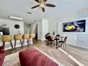 Open-concept living space with modern furniture, a large TV, and sleek finishes at 7670 Otterspool St, Kissimmee, FL 34747