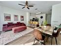 Inviting open-concept living and dining area featuring modern decor, stylish furniture, and natural light at 7670 Otterspool St, Kissimmee, FL 34747