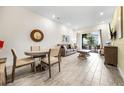 Bright living room with wood tile floors, a dining table and comfortable seating overlooking a backyard patio at 8012 Lost Shaker Ln, Kissimmee, FL 34747