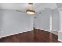 Dining room showcasing hardwood floors and modern light fixture at 923 Tramells Trl, Kissimmee, FL 34744