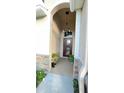 Inviting front entrance with decorative plants, stone accents and hanging light fixture at 14112 Queenside St, Orlando, FL 32824