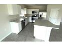 Bright kitchen with white cabinetry, stainless steel appliances and center island at 1629 Ambar Ct, Winter Haven, FL 33881