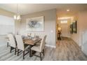 Formal dining room featuring stylish light fixture, seating for six, and luxury vinyl plank flooring at 1646 Moon Valley Dr, Davenport, FL 33896