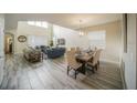 Open floor plan featuring living and dining spaces with luxury vinyl plank flooring and lots of natural light at 1646 Moon Valley Dr, Davenport, FL 33896