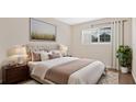 Cozy bedroom with a tufted headboard, soft lighting, and a view from the window, all on a plush rug at 1695 Lee Rd # E103, Winter Park, FL 32789