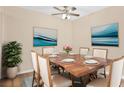 Formal dining room featuring elegant wood table set for six with modern lighting at 1695 Lee Rd # E103, Winter Park, FL 32789