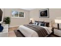 Comfortable bedroom with large window, plush bed and neutral color palette at 1695 Lee Rd # E103, Winter Park, FL 32789