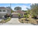 A charming tan home with a well-manicured lawn and attached garage in a desirable neighborhood at 217 Sand Ridge Dr, Davenport, FL 33896
