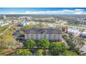 An aerial view showcases the multi-story hotel building and surrounding landscape at 3000 Maingate Ln # 424, Kissimmee, FL 34747