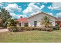 Charming single-story home with a manicured lawn, mature landscaping, and a welcoming facade at 318 Rock Springs Dr, Poinciana, FL 34759