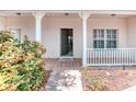 Inviting covered porch with classic columns and a brick-paved walkway leading to the front door at 318 Rock Springs Dr, Poinciana, FL 34759