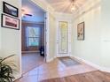 Welcoming foyer with tile flooring, a decorative front door, and a view into the adjacent living spaces at 400 Indian Wells Ave, Poinciana, FL 34759