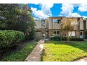 Charming townhome exterior featuring a well-maintained lawn and a quaint walkway leading to the front door at 406 Oak Haven Dr # 406, Altamonte Springs, FL 32701