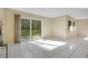 Living room featuring ceramic tile flooring, sliding glass doors and neutral paint and lots of natural light at 406 Oak Haven Dr # 406, Altamonte Springs, FL 32701