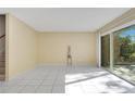 Bright living room featuring ceramic tile floors, sliding glass doors with lots of natural light, and neutral paint at 406 Oak Haven Dr # 406, Altamonte Springs, FL 32701