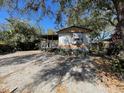 A single-story house with a covered porch and an expansive driveway at 413 4Th St, Orlando, FL 32824