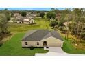 An overhead view of a single-story home highlighting its well-maintained landscaping at 43 Peterlee Ct, Kissimmee, FL 34758