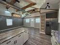 Open-concept living area with high ceilings, modern lighting, and wood-look flooring offers a spacious design at 430 Connecticut Ave, St Cloud, FL 34769