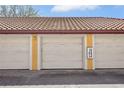 Exterior shot of condo garages with red tile roofing at 6153 Metrowest Blvd # 103, Orlando, FL 32835