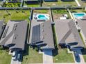 Aerial view of a home with solar panels and a private pool at 649 Meadow Pointe Dr, Haines City, FL 33844