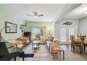 Bright living room featuring neutral furniture, ceiling fan, and a large window at 651 Highlands Hammock Dr, Poinciana, FL 34759