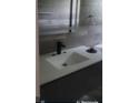 Bathroom featuring modern fixtures, a gray tiled wall, and a vanity at 717 Michigan Ct # 2, St Cloud, FL 34769