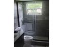 Bathroom featuring modern fixtures, a glass enclosed shower, and a window at 717 Michigan Ct # 2, St Cloud, FL 34769