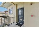 A welcoming condo entryway with a modern gray door and exterior balcony at 901 Charo Pkwy # 731, Davenport, FL 33897