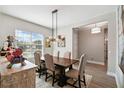 Elegant dining room with stylish lighting, modern decor, and a view of the neighborhood at 937 Walnut Creek Ln, Poinciana, FL 34759