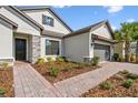 Beautiful single-Gathering home featuring a brick walkway, two-car garage, and freshly landscaped yard at 937 Walnut Creek Ln, Poinciana, FL 34759